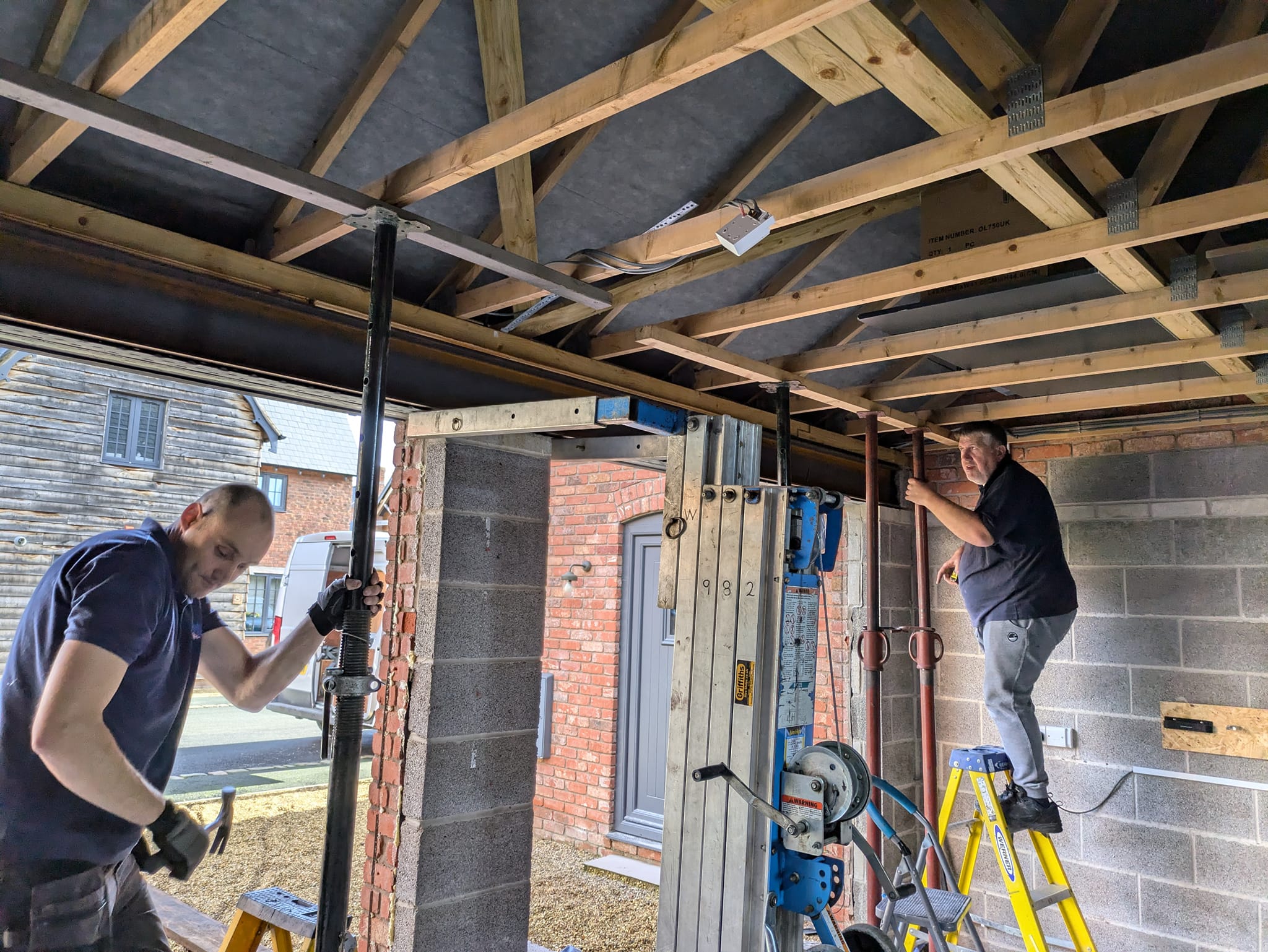 2 men fixing a garage door in Telford