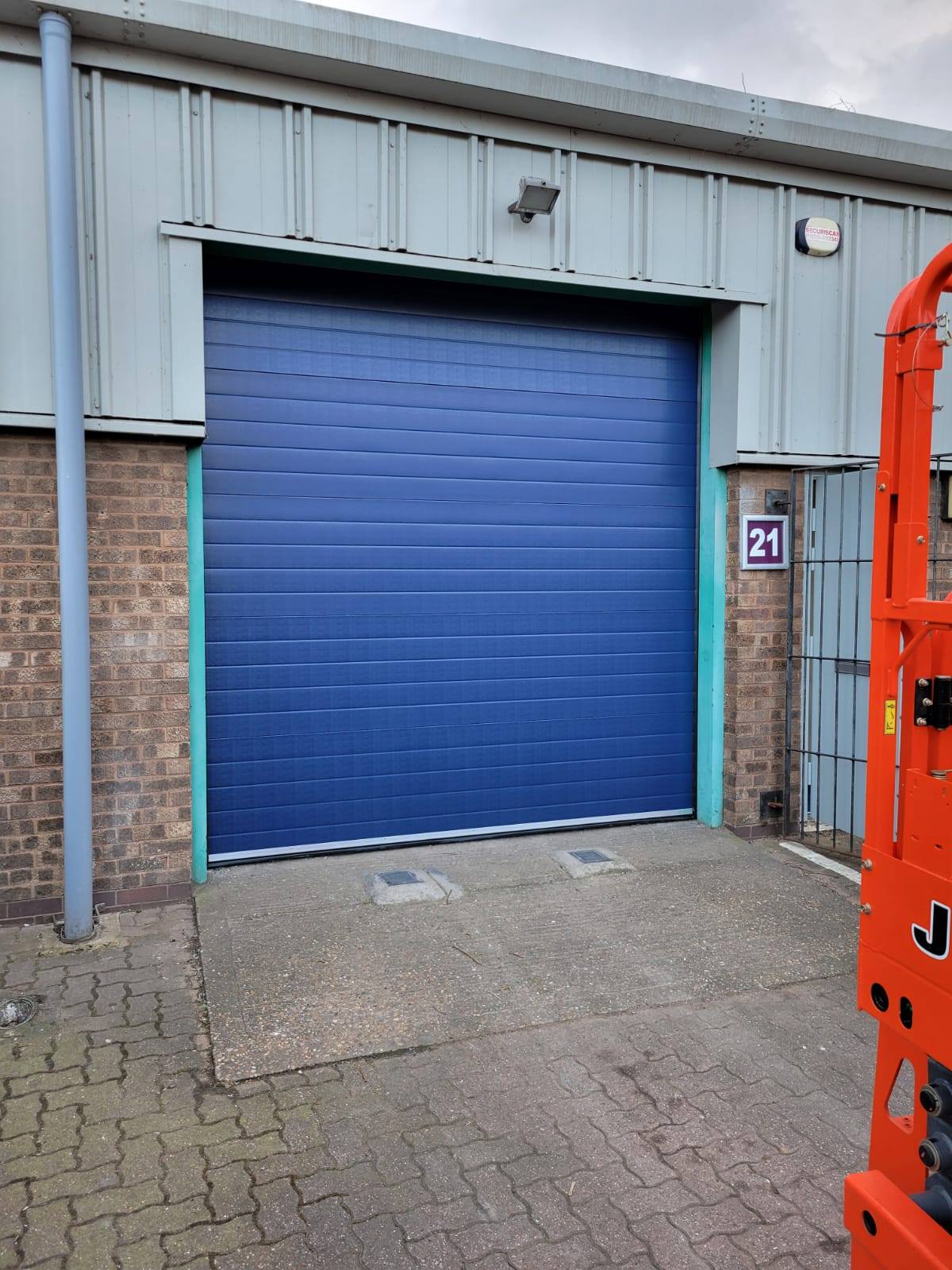 Blue automatic sectional garage door in Telford