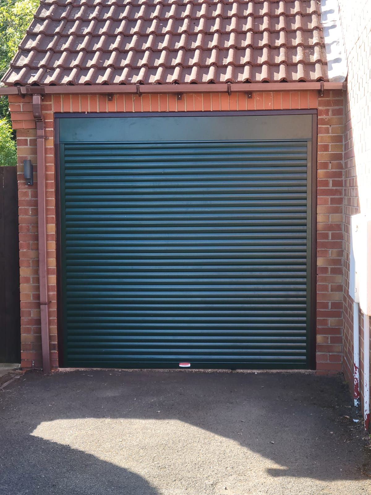 Green roller garage door in Telford