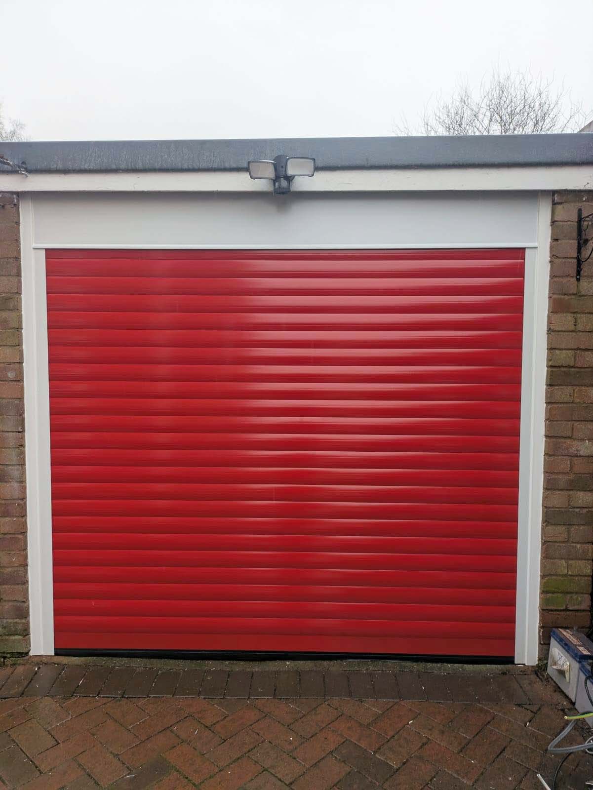 Red roller garage door in Telford